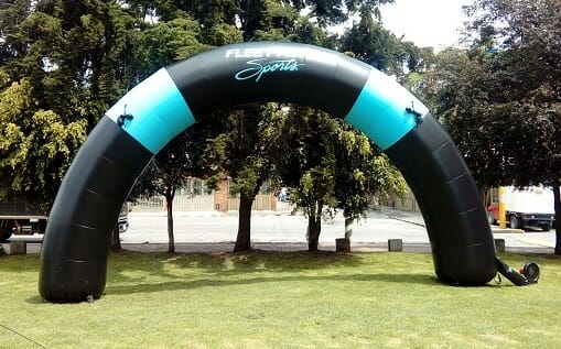 Fleet Feet Sports Curved Turquoise & Black Inflatable Arch - Boulder Blimp